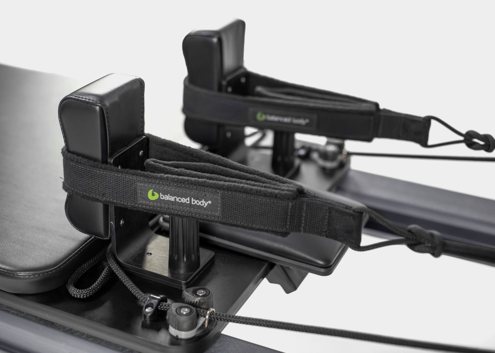 Close-up of the hand and foot handles on the Allegro Nextgen Pilates Reformer.