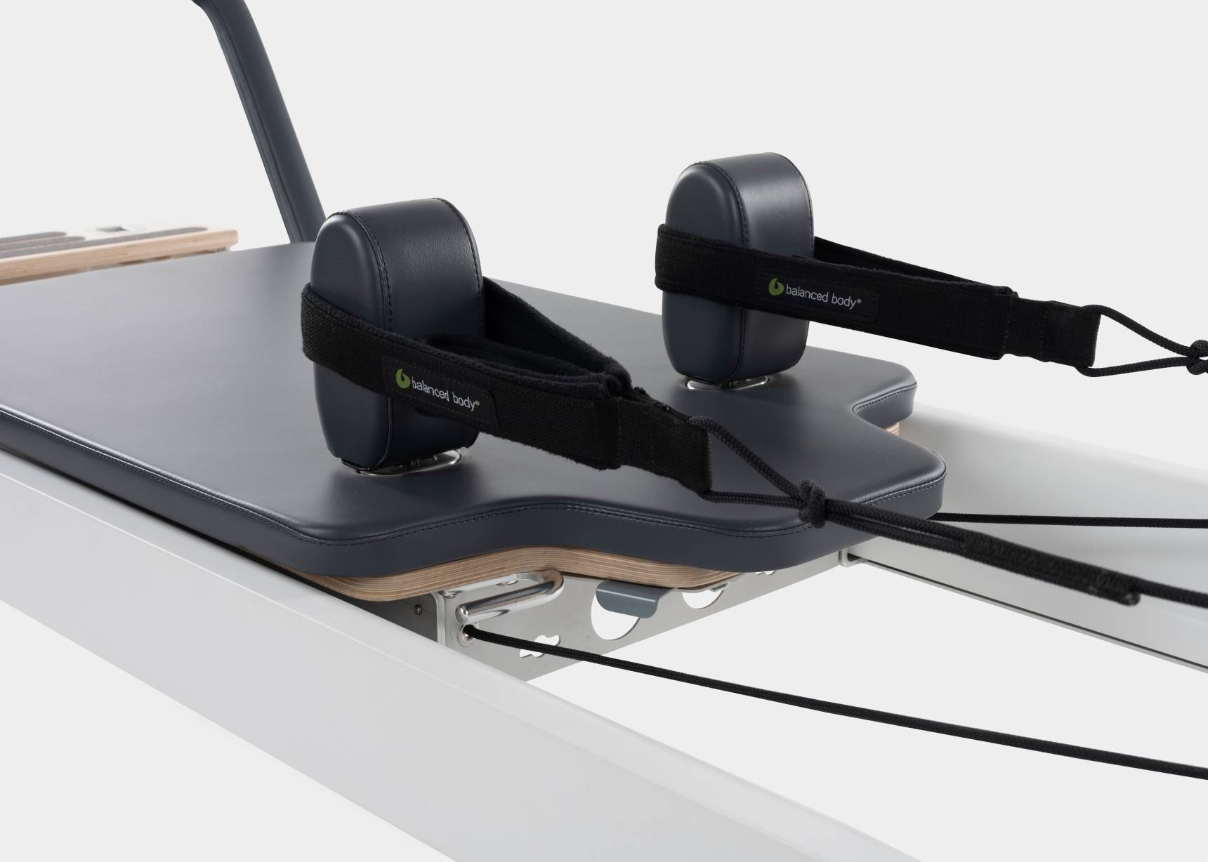 Close-up of the foot straps on a Balanced Body aluminum Pilates reformer.