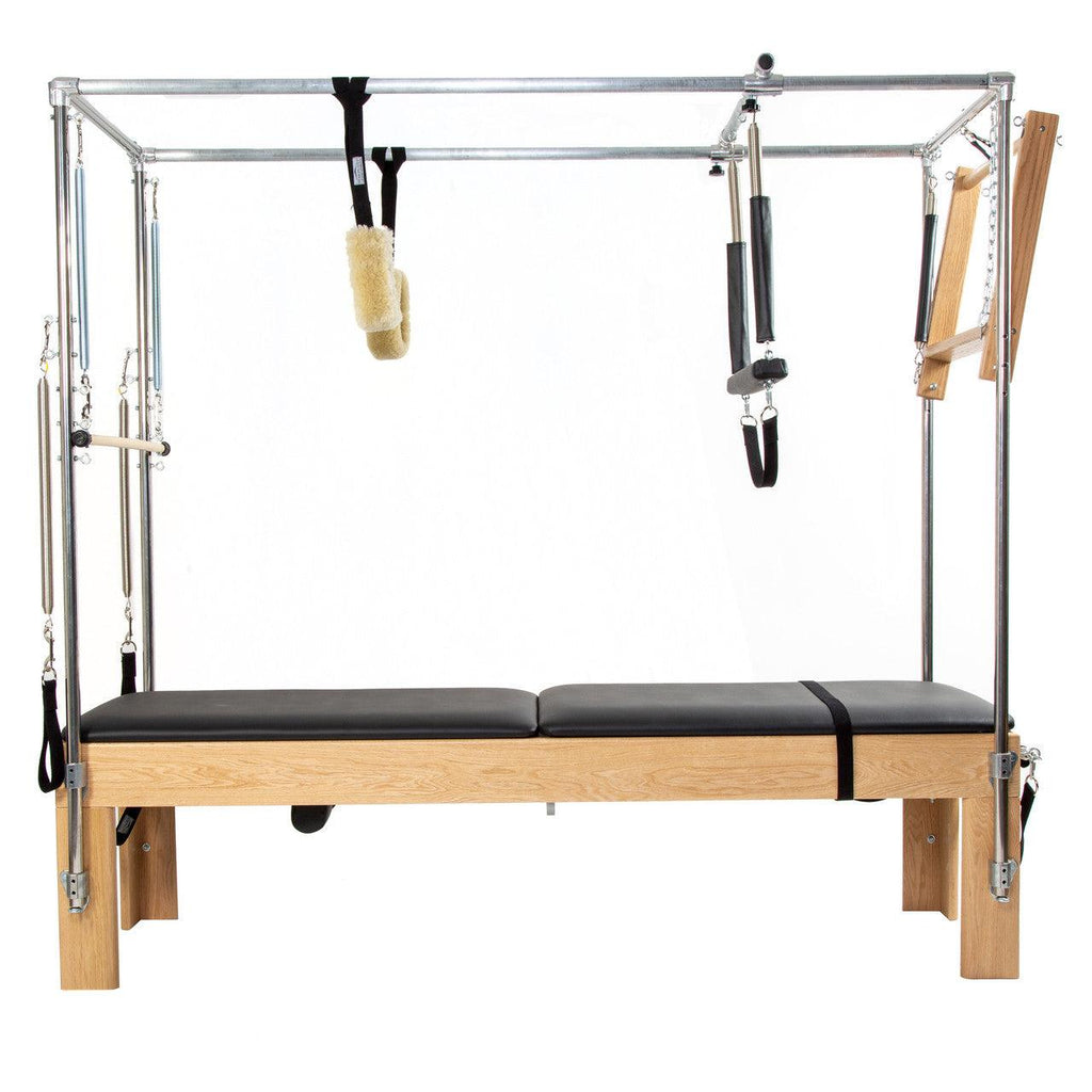 Full view of a wooden Cadillac Tower Pilates reformer.