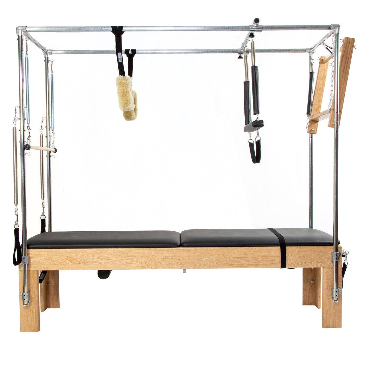 Full view of a wooden Cadillac Tower Pilates reformer.