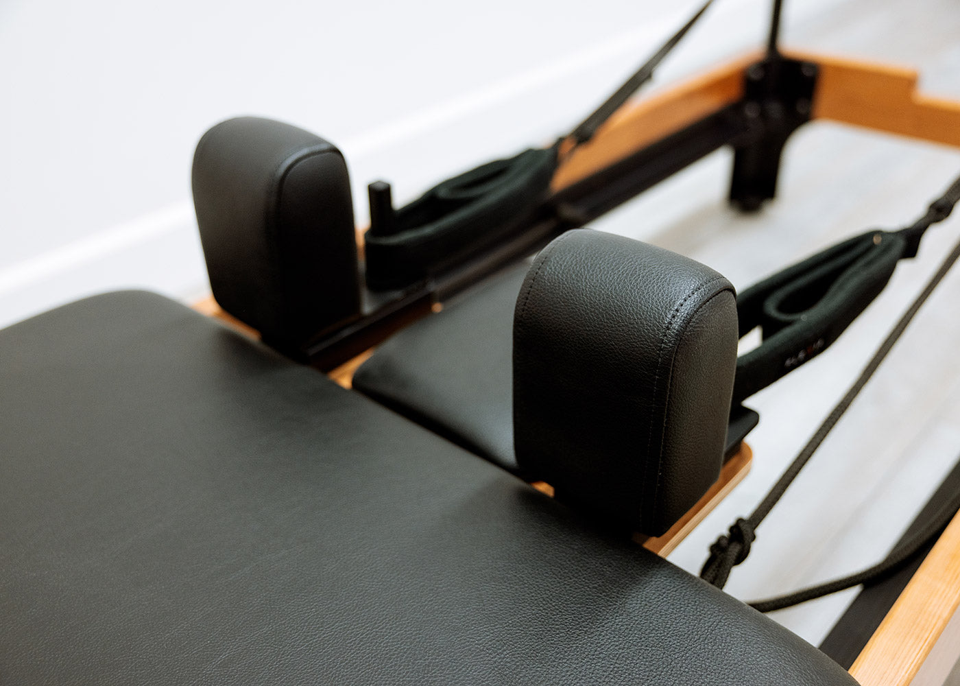 Adjustable shoulder rests on a high-end Flexia Pilates reformer.