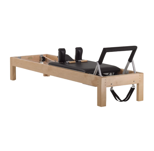 Traditional wood Pilates reformer with black padding, luxury equipment.